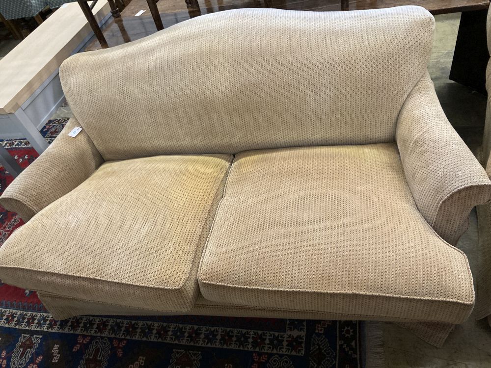 A pair of contemporary beige upholstered two seater settees, width 180cm depth 106cm max height 80cm